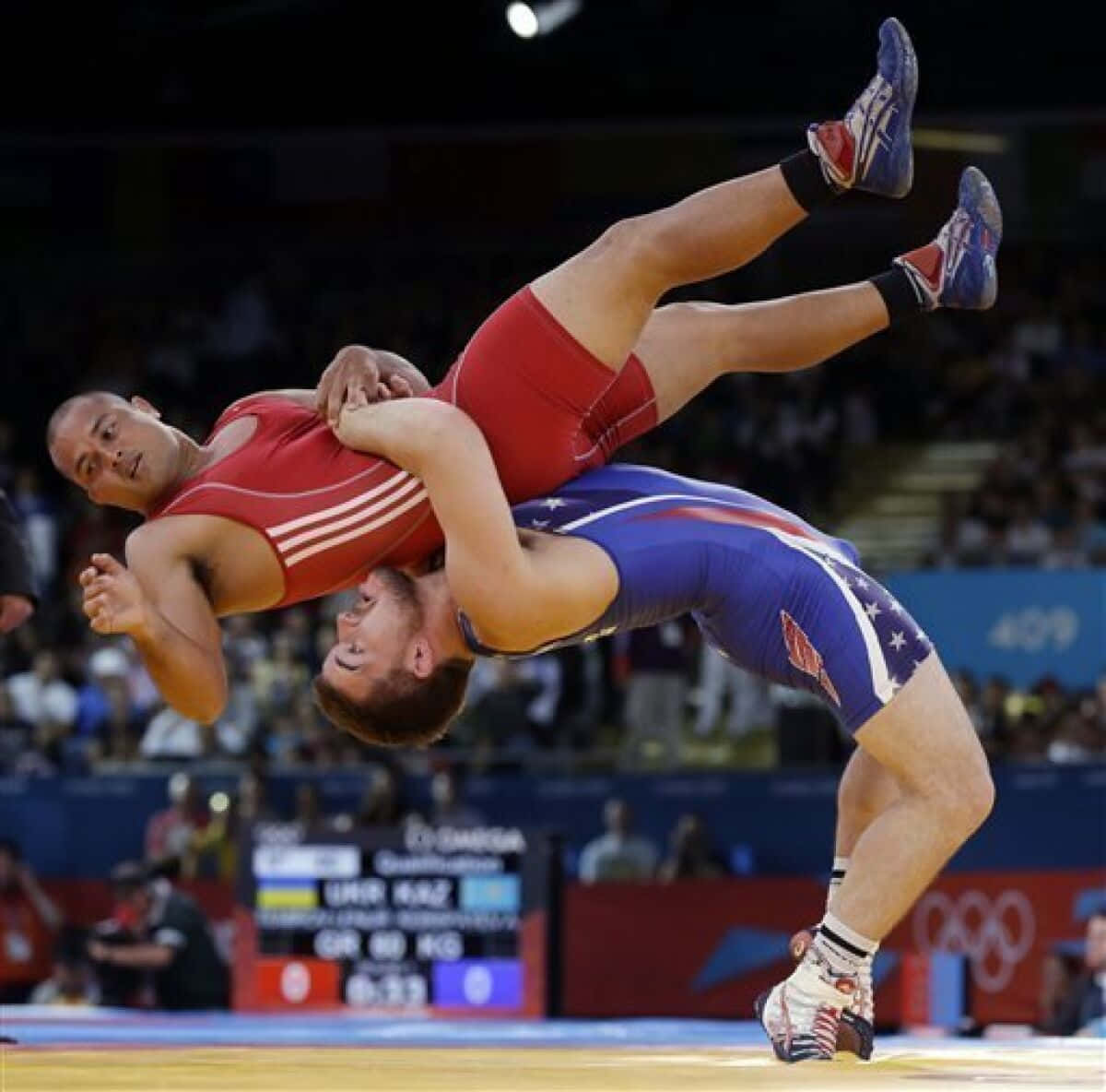 Two wrestlers competing on the mat